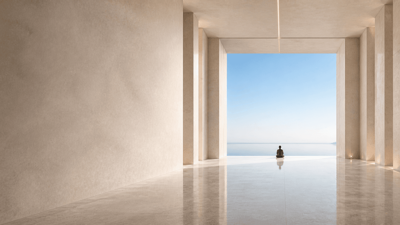 A serene architectural corridor opening toward water and the morning horizon